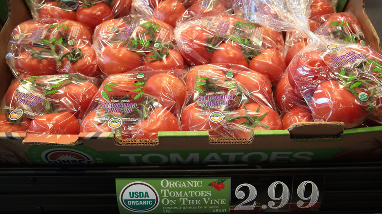 A box of plastic-bagged tomatoes in an Aldi store