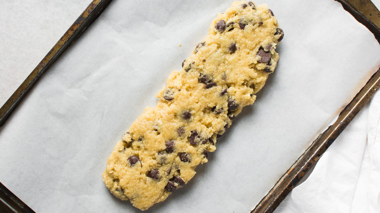 cookie dough biscotti dough on a cookie sheet with parchment paper