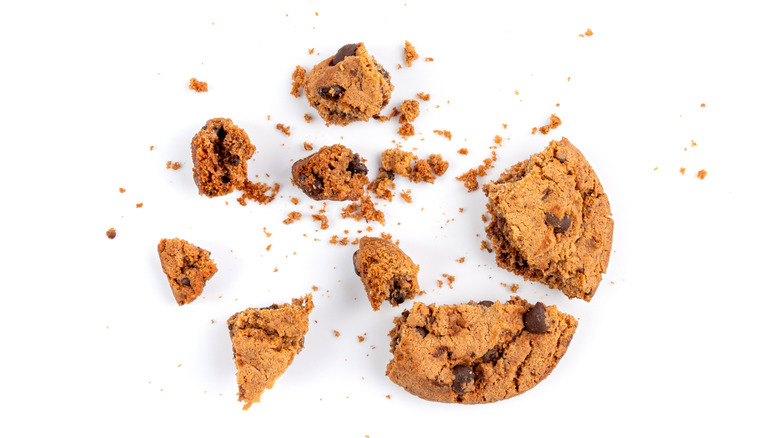 broken chocolate chip cookie and crumbs