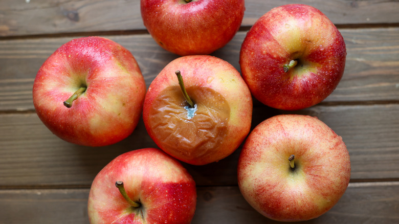 Bruised apples on a wooden table