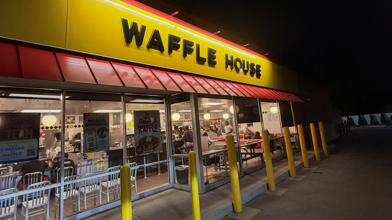 The exterior of a Waffle House Restaurant at night.