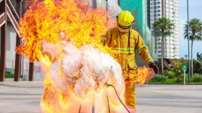 Firefighters teach or demonstrate the fire by pouring water into a very hot oil pan