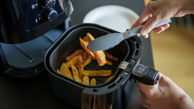 Person cooking with an air fryer