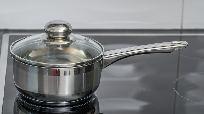 Steel saucepan with handle on an induction hob