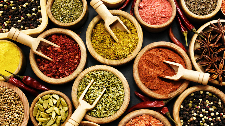 Various dried seasonings in wood bowls