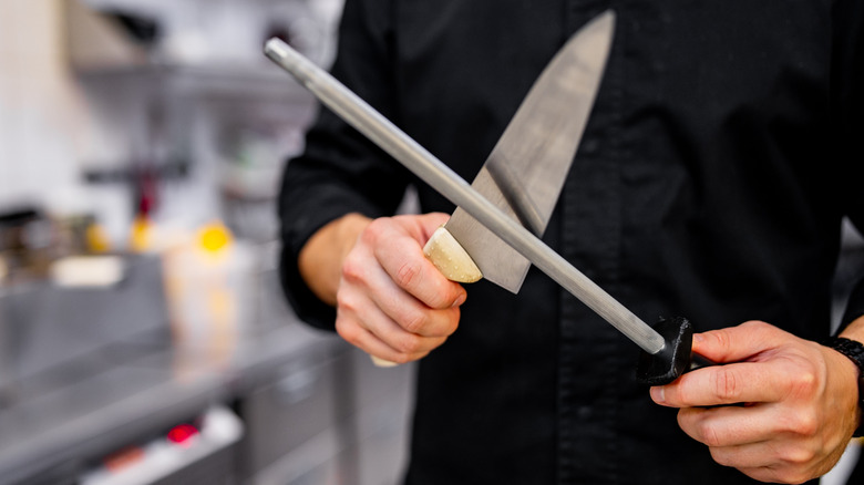 A chef honing a knife