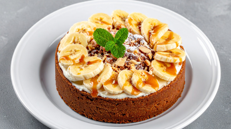 cheesecake with Banana and Caramel on a white plate