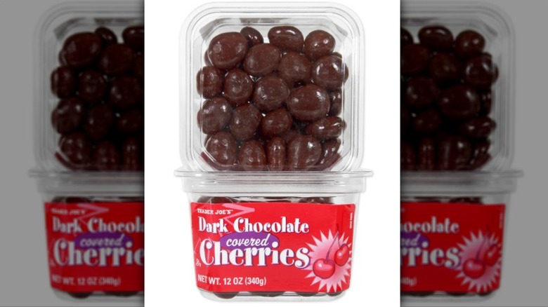 Two plastic containers of Trader Joe's dark chocolate covered cherries on white background