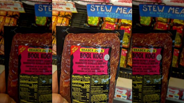 Someone holding a package of Trader Joe's bool kogi inside the store