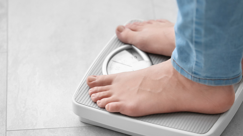 a person's feet are shown standing on a scale as they weighs themself