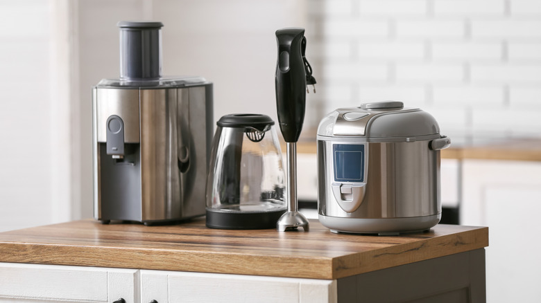 Multiple kitchen tools on wooden countertop