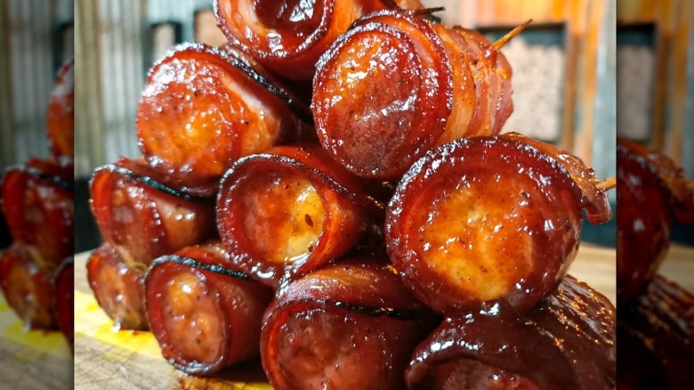 shiny bacon-wrapped banana pieces stacked in a pyramid with toothpicks