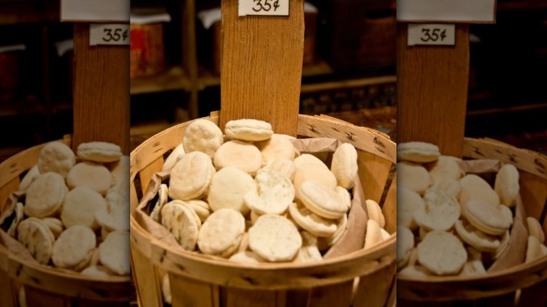 a wooden basket filled with white, circular crackers with a small 35 cent sign above
