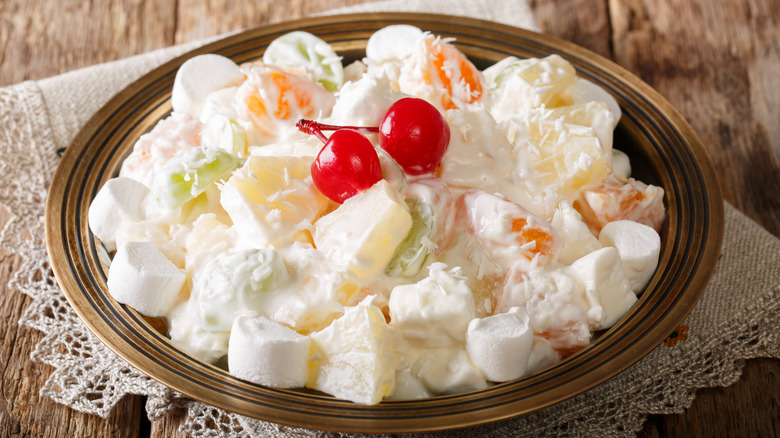 Ambrosia salad in bowl on rustic background