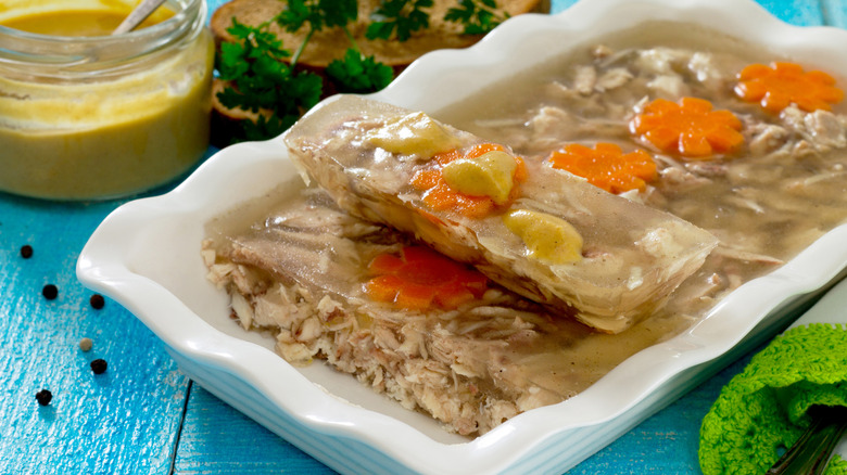 Jellied chicken in a dish with slice cut out
