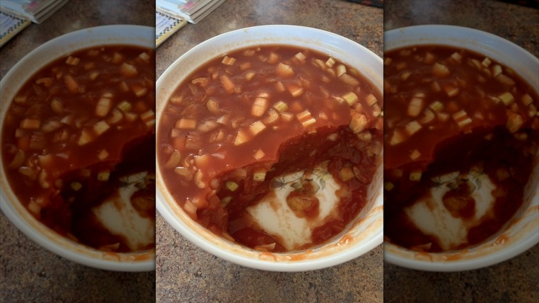 Chunky tomato aspic in bowl with scoops removed