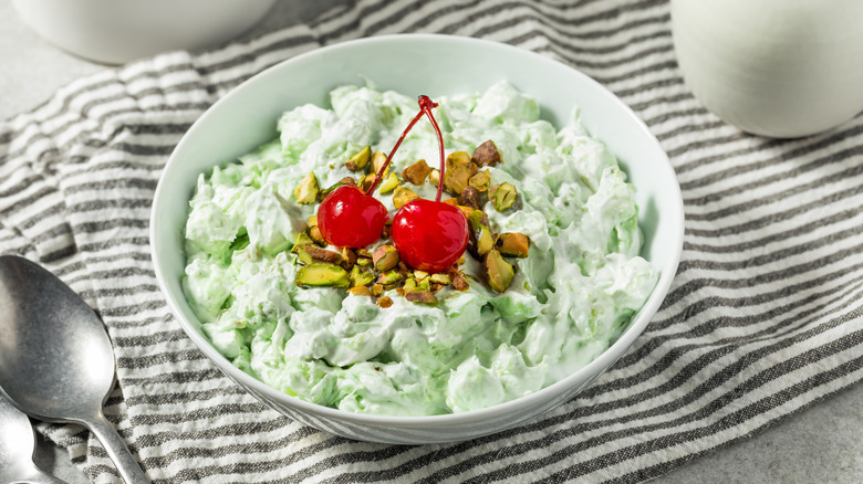 Watergate salad in white bowl on striped cloth