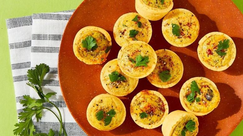 plate of bettergoods mini quiches accompanied by a striped cloth napkin