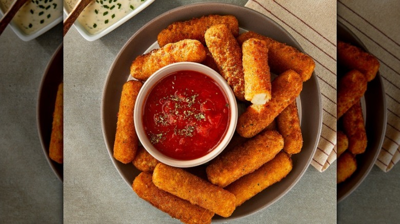 bowl of Great Value mozzarella sticks with cup of marinara sauce