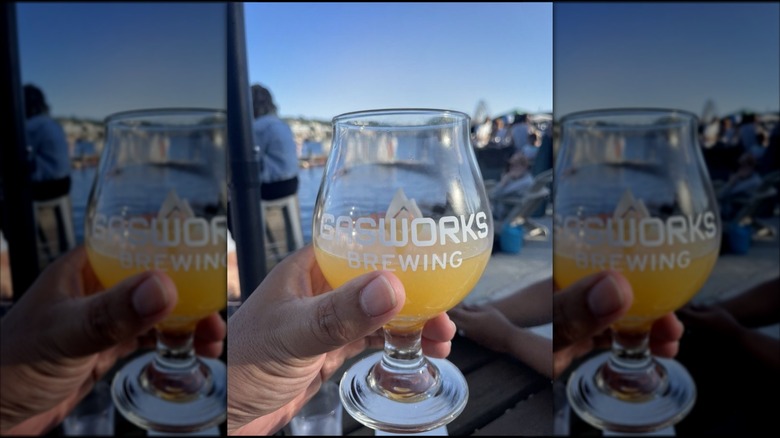 Gasworks Brewing glass with beer and Lake Union in the background