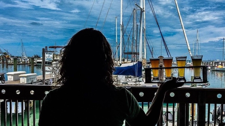 A waitress bringing beers out to the patio of The Waterfront Brewery in Key West, Florida