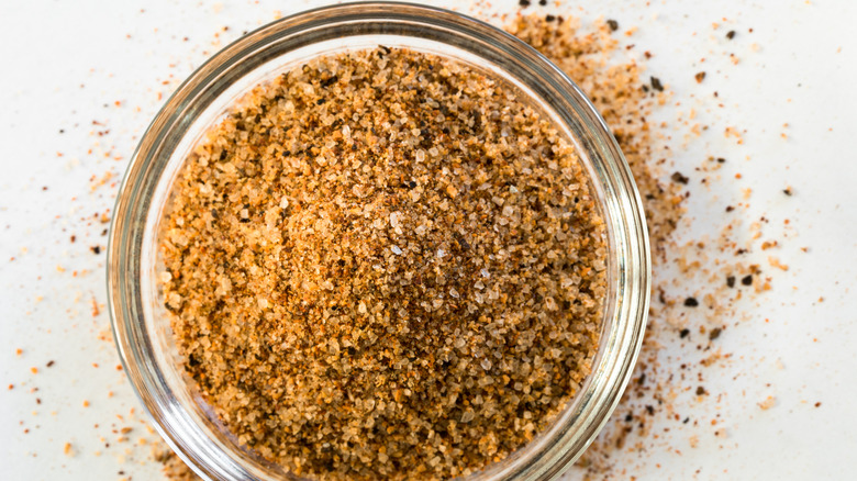 A close-up of Cajun seasonings in a glass jar