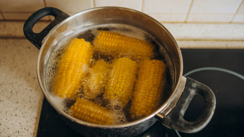 Corn boiling in a pot on a stove