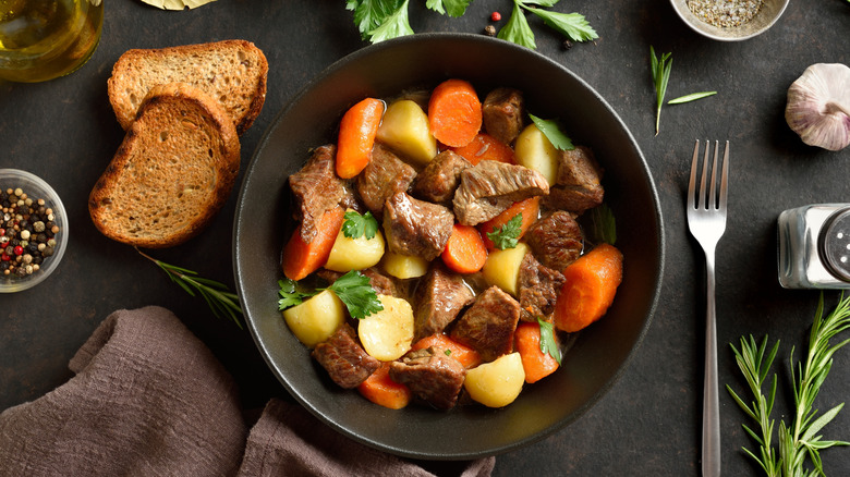A black bowl of beef stew