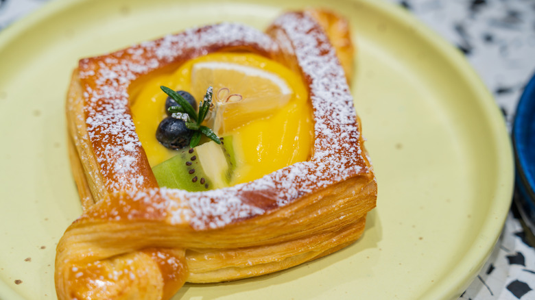 A pastry topped with lemon curd and fresh fruit