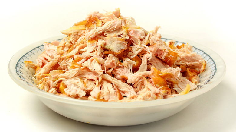 Shredded chicken on a white and blue plate