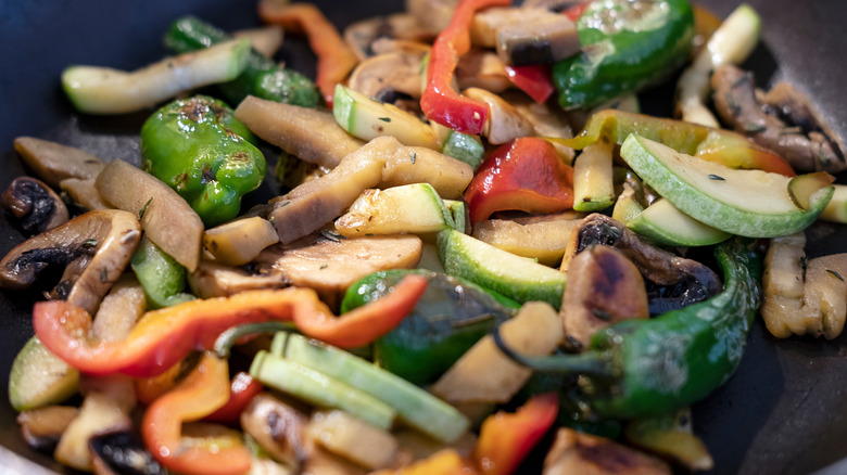 A colorful mix of sauteed veggies in a pan