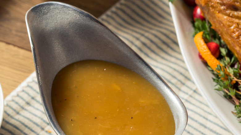 Brown gravy in a metal gravy boat