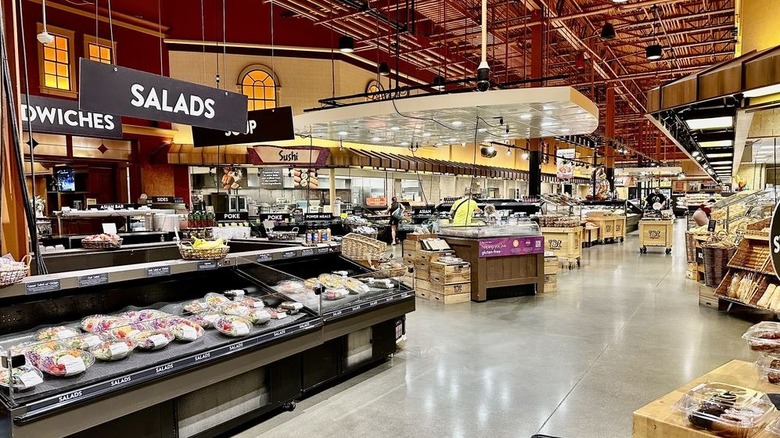 Wegmans prepared food aisle with sandwiches, salads, soups, and sushi counters