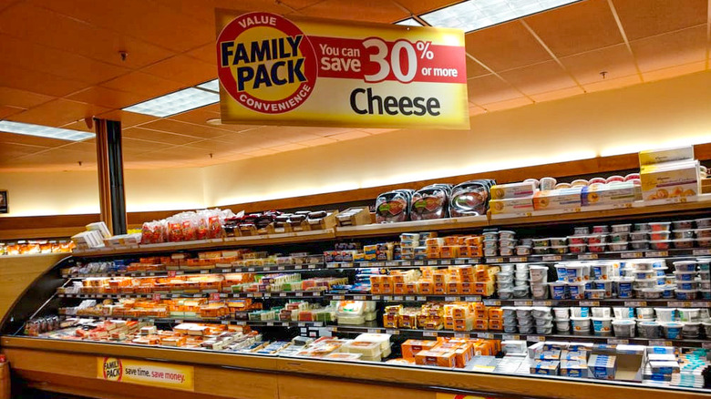 Wegmans refrigerated display featuring family pack cheeses