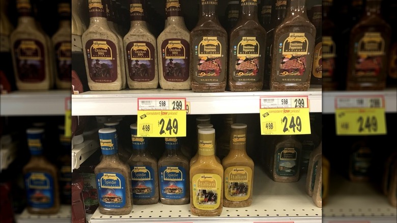 Grocery shelves at Wegmans with various store-brand salad dressings on sale