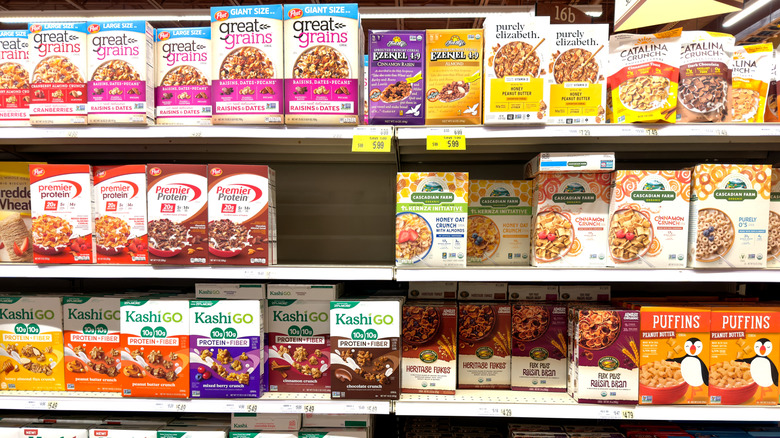 The cereal aisle at Wegmans with name brand options on shelves like Kashi Go, Premier Protein, and purely Elizabeth