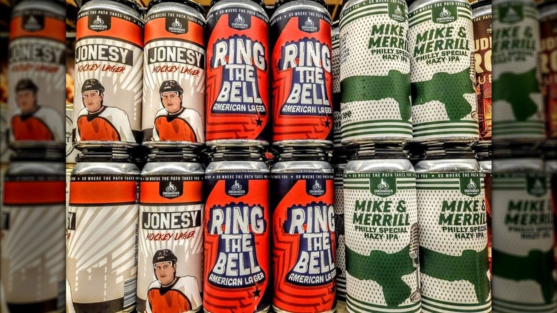 tall boy cans of local craft beer at a Wegmans grocery store, including Jonesy lager, Ring the bell american lager, and mike and merrill IPA