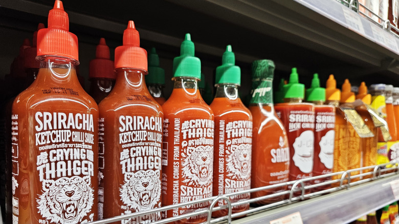 Bottles of sriracha sauce on a store shelf