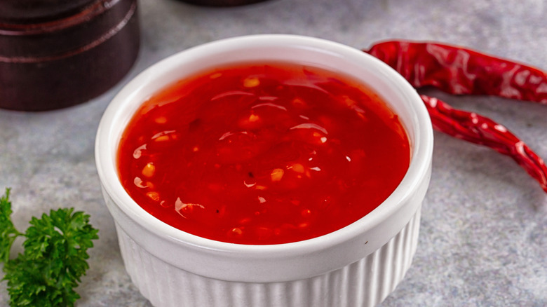 A white bowl of sweet and sour chili sauce
