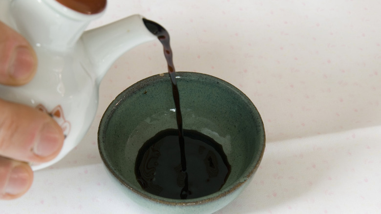 Soy sauce being poured into a dish