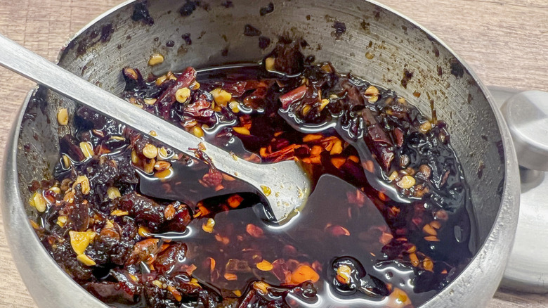 A metal bowl of chili oil