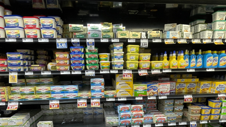 A selection of different butter options in the grocery store aisle