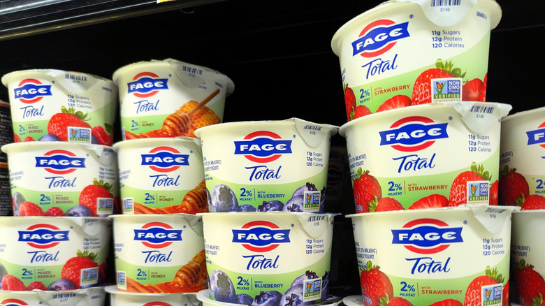 Berry, honey, blueberry, and strawberry Fage yogurts stacked in refrigerator