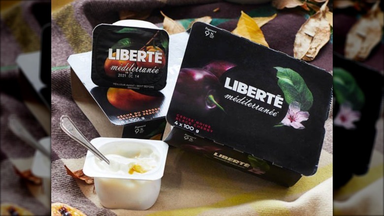 Liberte yogurt opened individual carton beside two multi packs