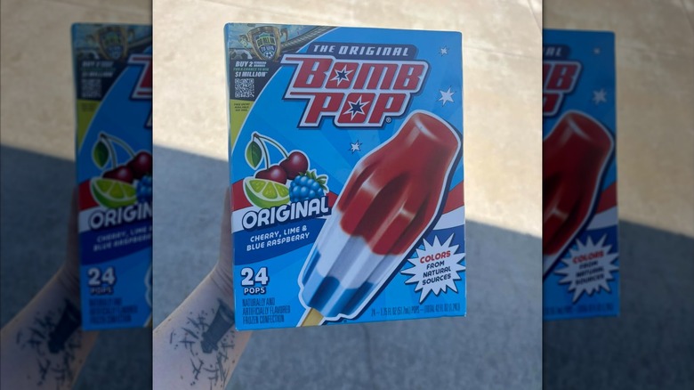 Hand holding a box of Bomb Pops