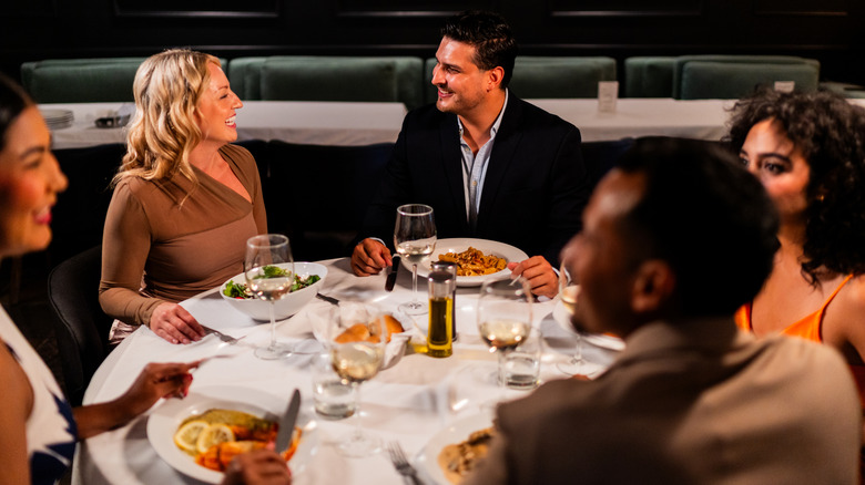A smiling group at a restaurant table.
