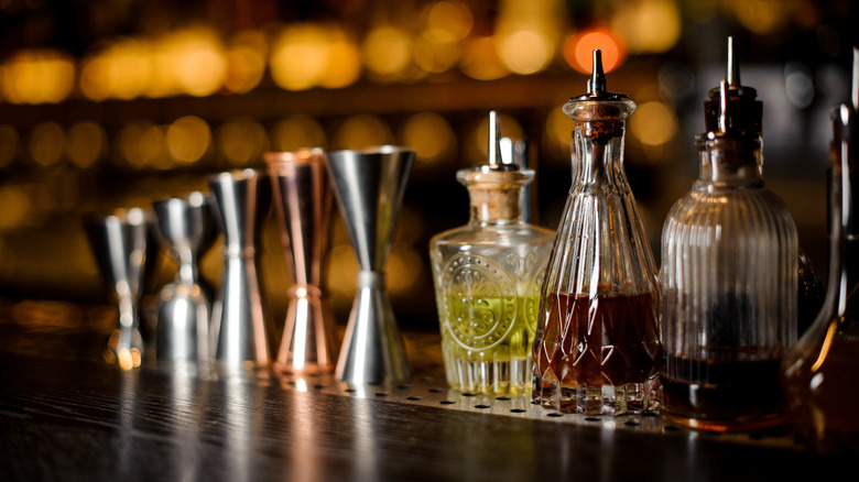 row of bottles of bitters on a bar
