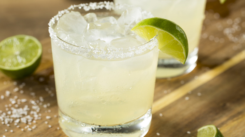 Margarita with salt rim and lime garnish