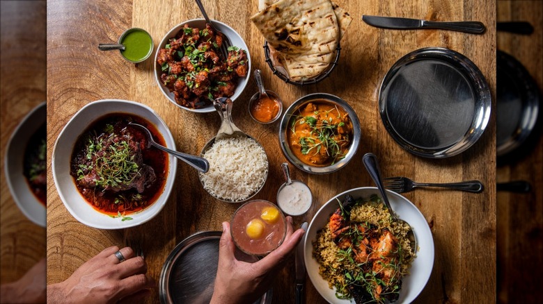 Tables with several Indian dishes