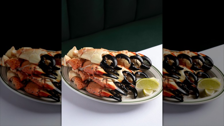 Stone crabs on a plate with lemon wedges